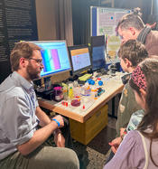 Jesse Jones demonstrating an absorption spectrometer experiment using pH indicators to reveal the fascinating changes in color as pH shifts